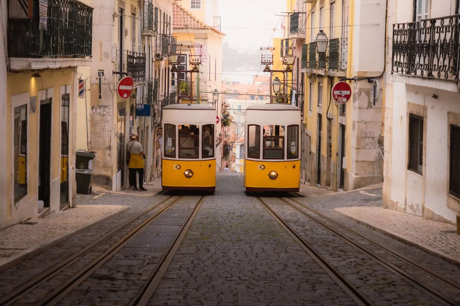 Charming yellow trams navigate the historic cobblestone streets of Lisbon's old town.