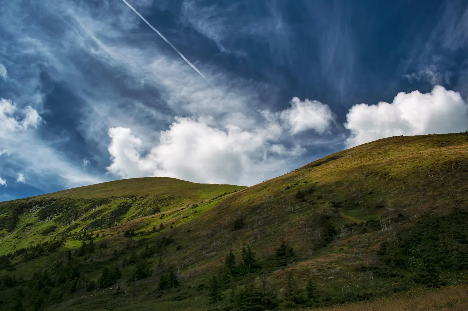 A breathtaking view of the Carpathian Mountains under a vivid sky in Zakarpattia, Ukraine.