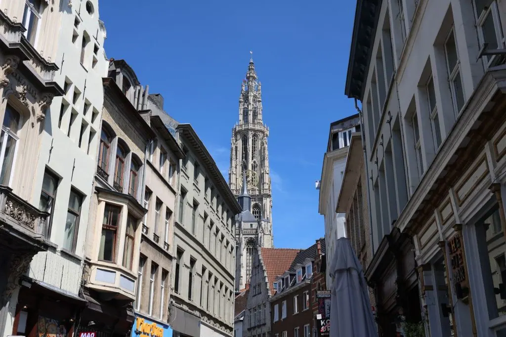 View of the Cathedral of Our Lady spire in Antwerp, showcasing Gothic architecture on a clear day.