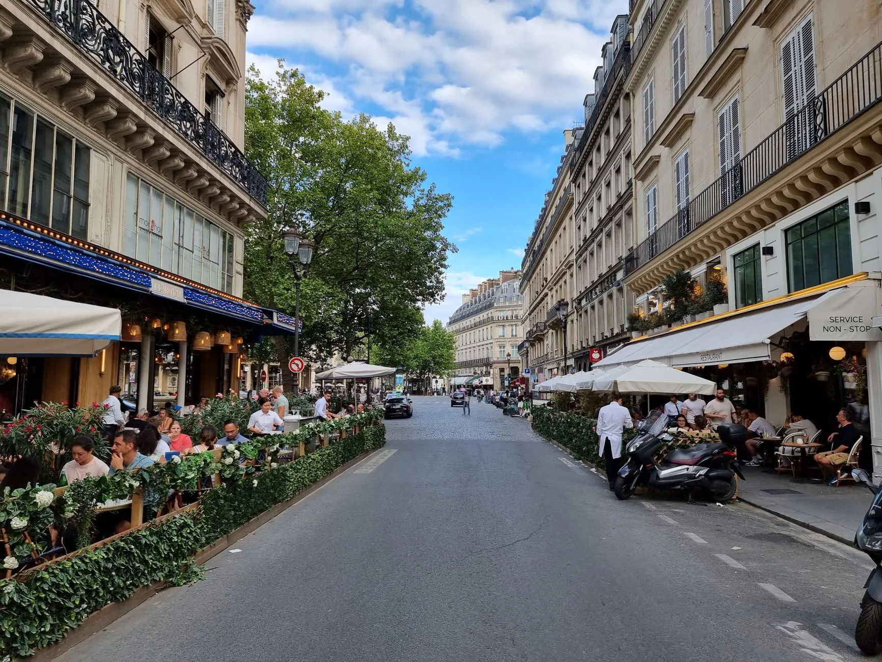 Paris street with outdoor cafe terraces