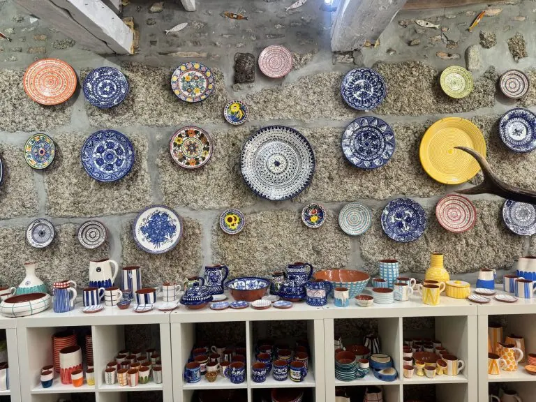 Hand-painted ceramic plates on display in a Portuguese artisan shop