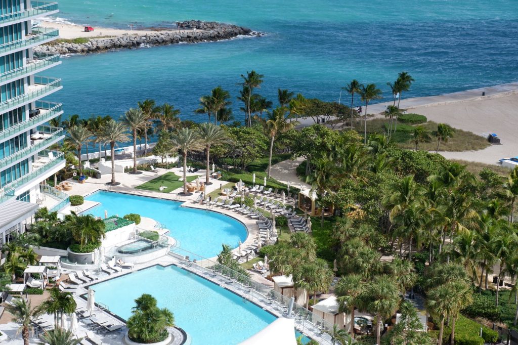 Lush Miami resort with pools and beachfront, offering a relaxing tropical escape.