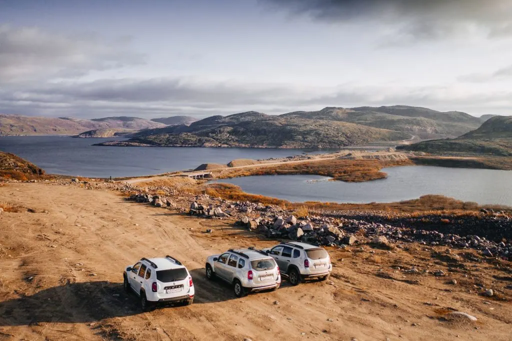 Off-road vehicles overlook the beautiful landscape in Teriberka, Russia.