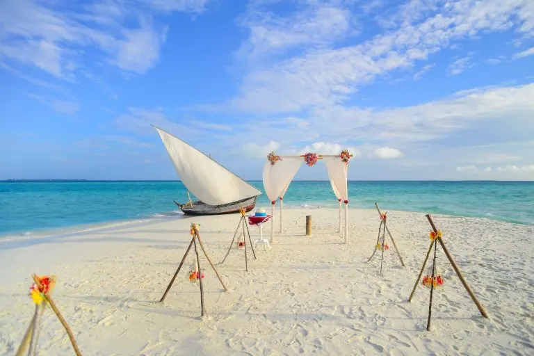 Wedding arch decorated with flowers on a beach