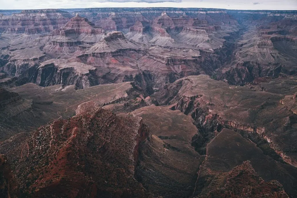 Breathtaking aerial view of the Grand Canyon showcasing its vast geological formations under a clear sky.