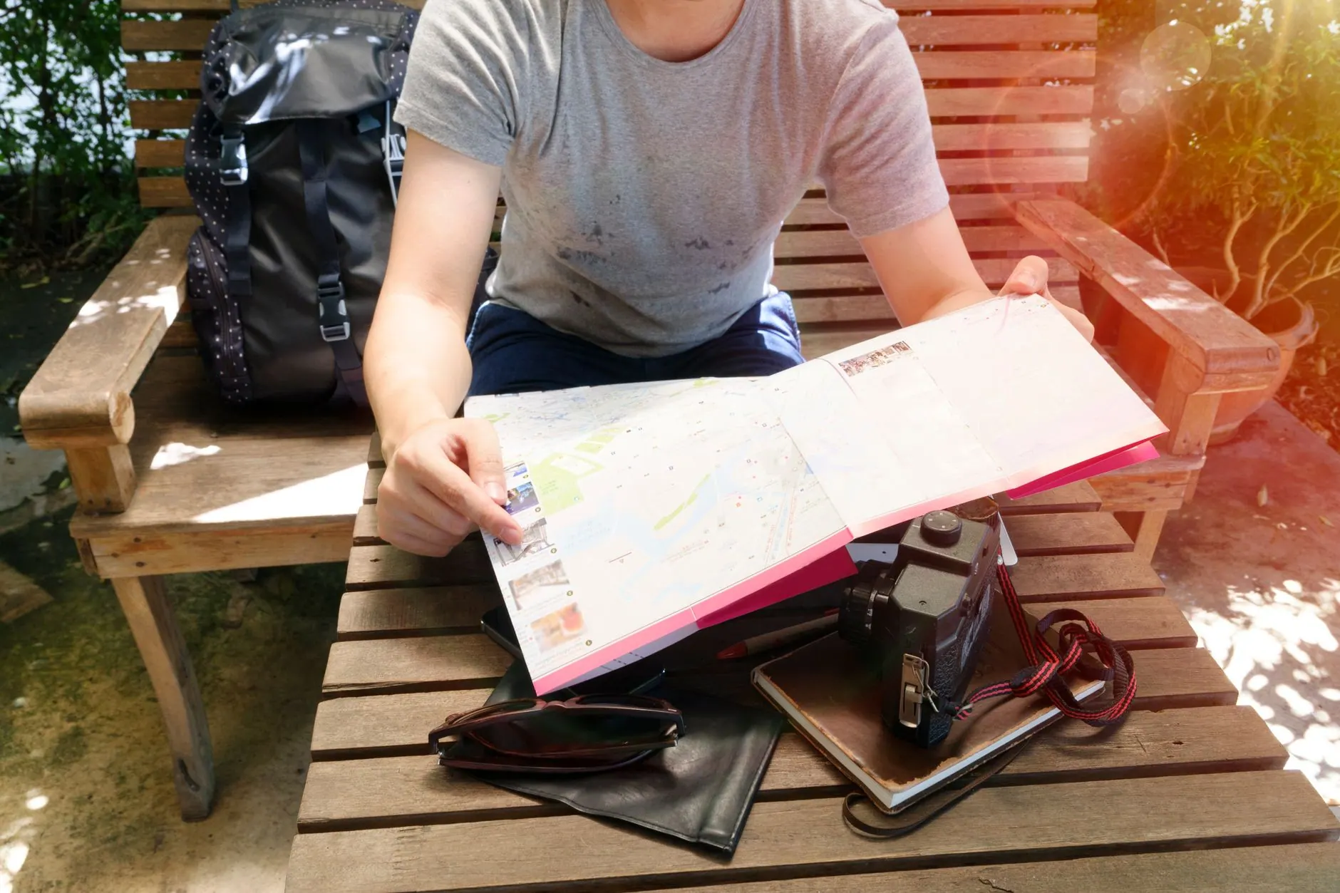 Traveller planning a budget trip with a map