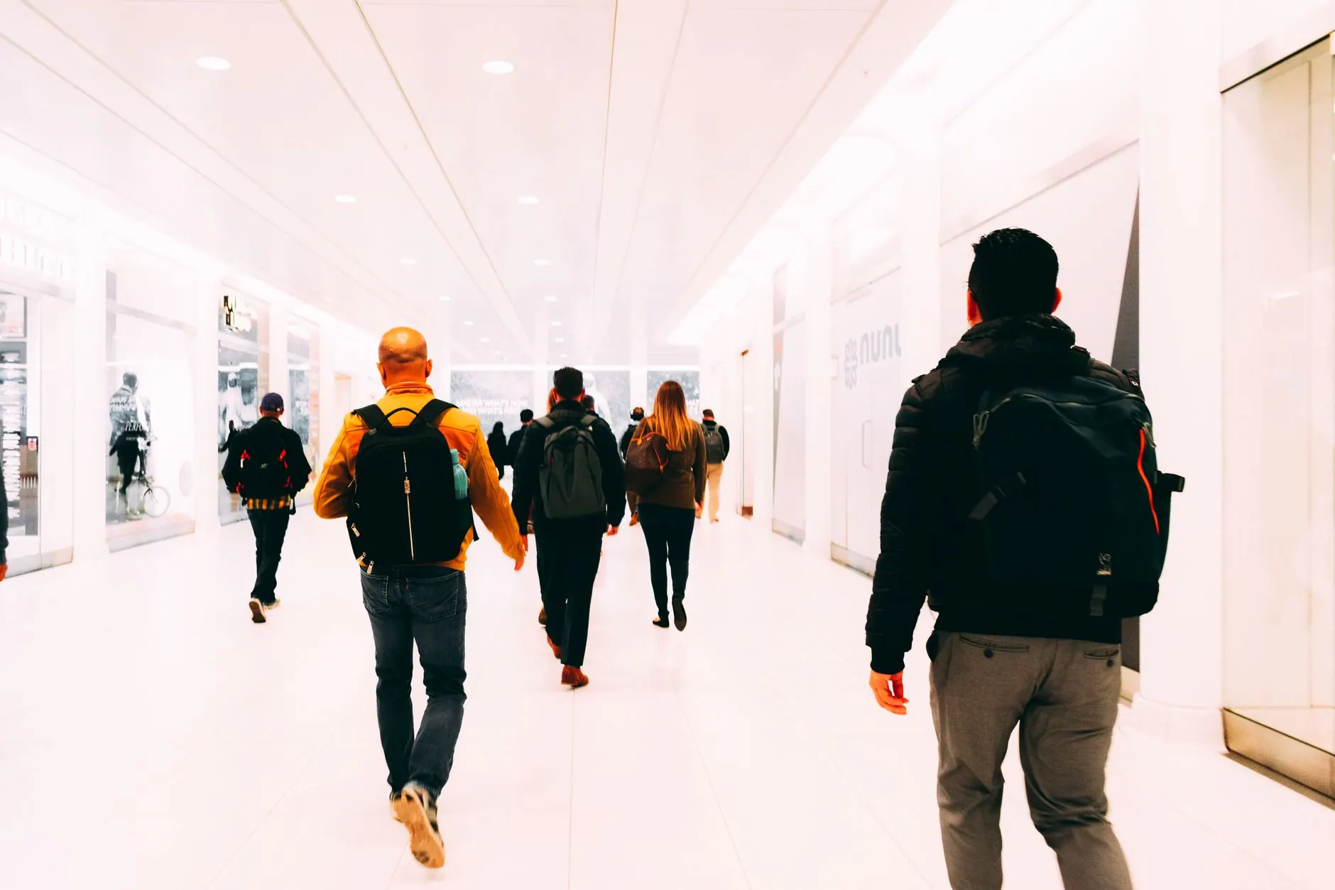 Traveller with a backpack walking through an airport