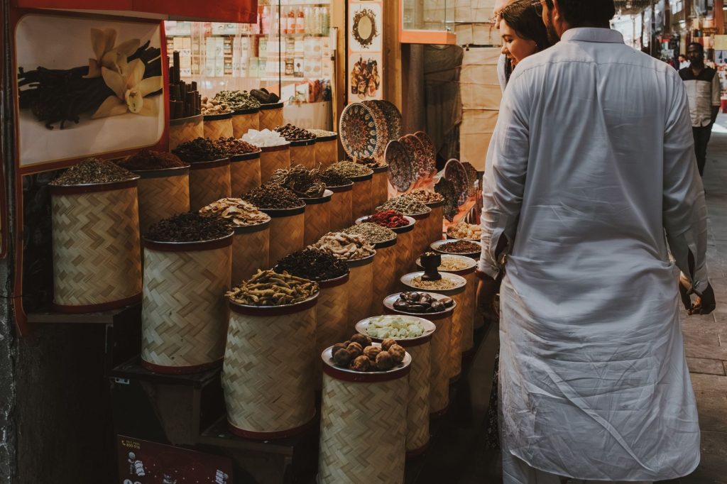 Explore the vibrant spice market scene in Dubai's traditional souq, showcasing exotic spices.
