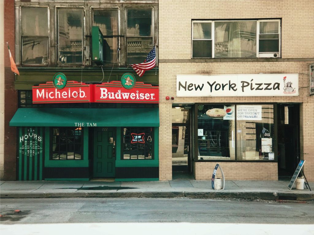 Photo of bar and pizza shop on a Boston street highlighting urban life.