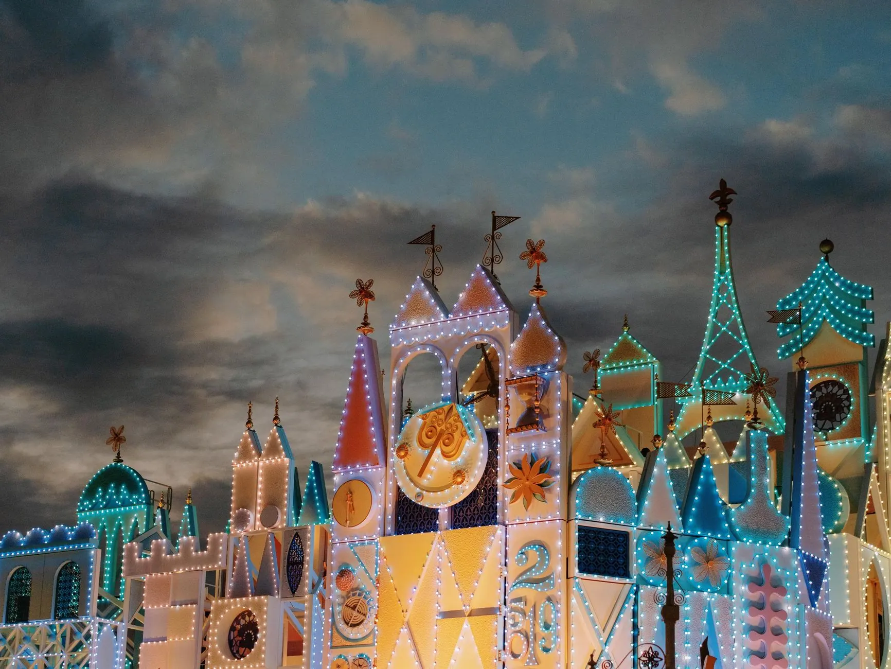 Fairy-tale castle at a theme park lit up in the evening