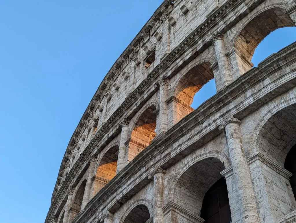 Capture of the Colosseum's architectural details during a beautiful sunset in Rome, Italy.
