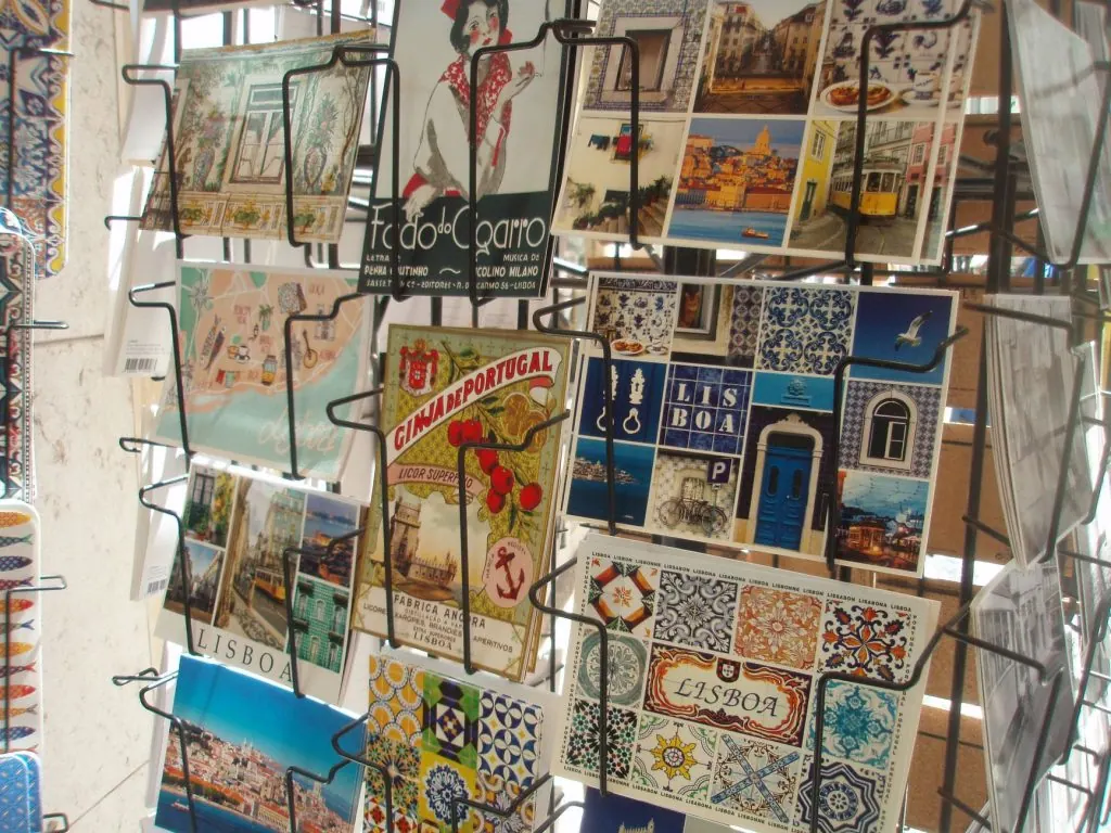 Vibrant postcards display Lisbon's famous tiles and landmarks, capturing the city's essence.