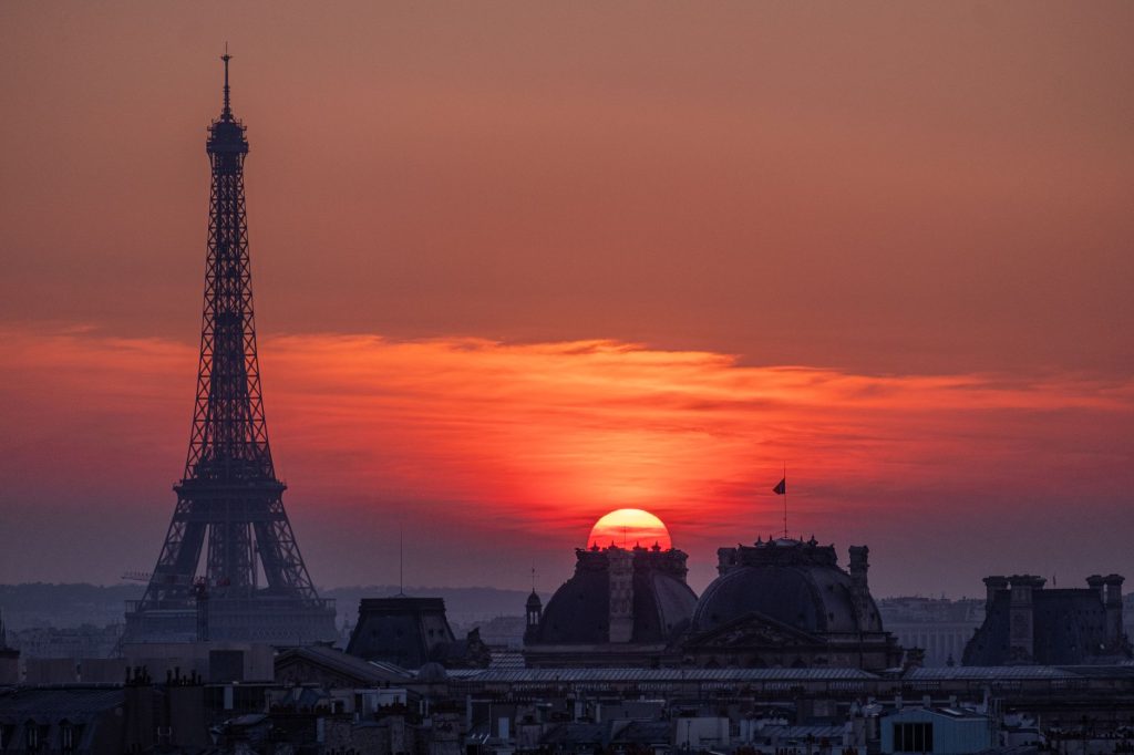 Experience the breathtaking sunset over Paris with the iconic Eiffel Tower silhouette.