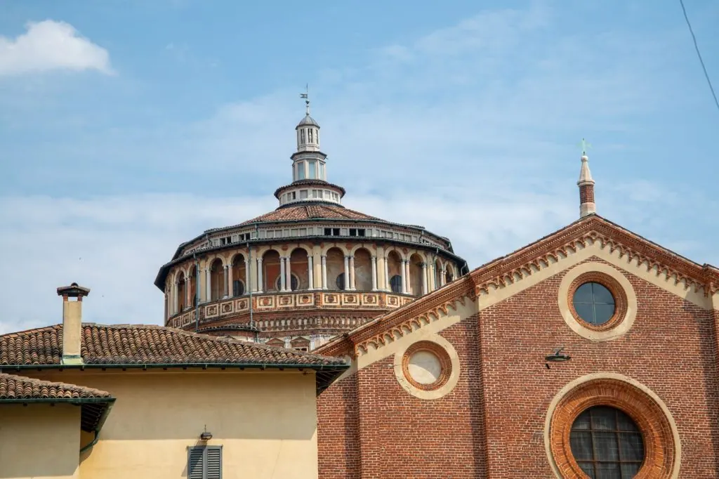 View of Santa Maria delle Grazie, a historic church in Milan, Italy, with unique architectural features.
