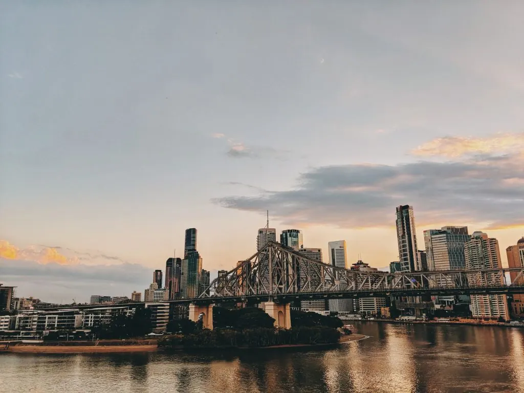 Scenic view of Brisbane skyline with Story Bridge at twilight over the Brisbane River.