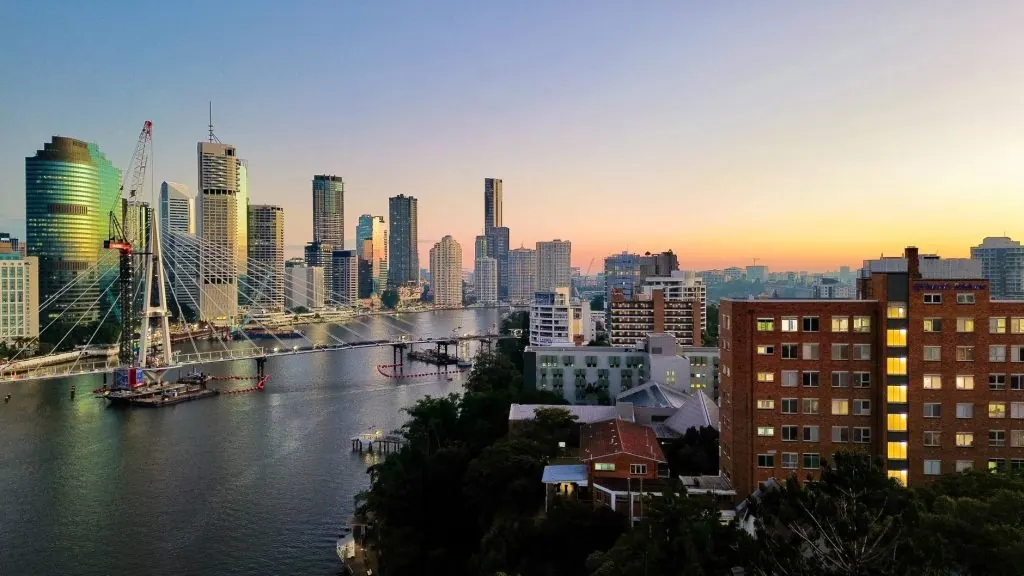 Stunning view of Brisbane skyline during sunset, overlooking the river and modern skyscrapers.