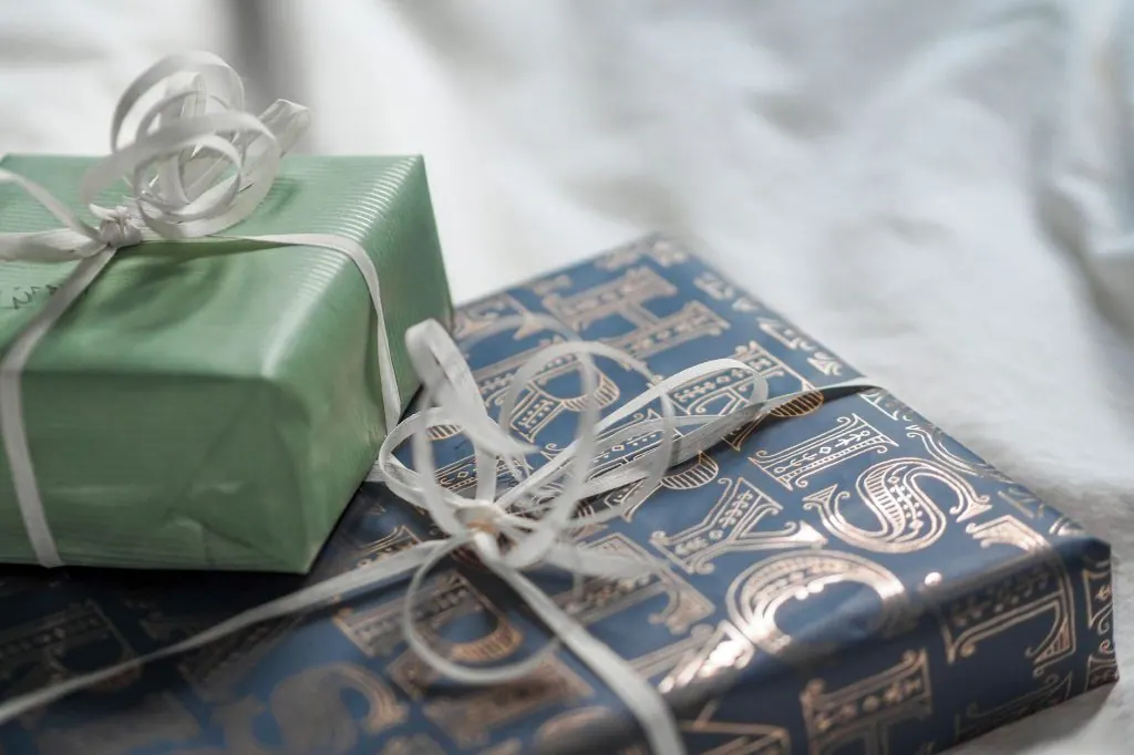 Close-up of elegant gift boxes wrapped in luxurious paper with delicate ribbons.