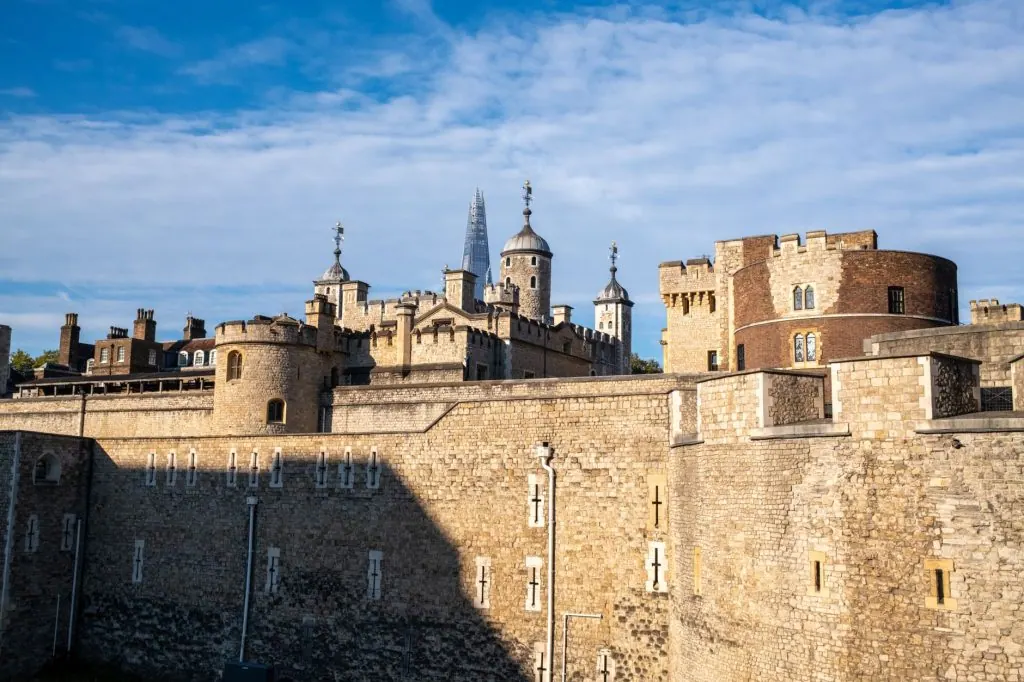 Explore the historic Tower of London against a clear blue summer sky, showcasing its iconic architecture.