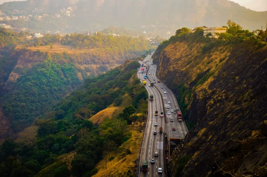 A scenic view of a busy highway winding through the lush hills of Lonavala, Maharashtra, India.