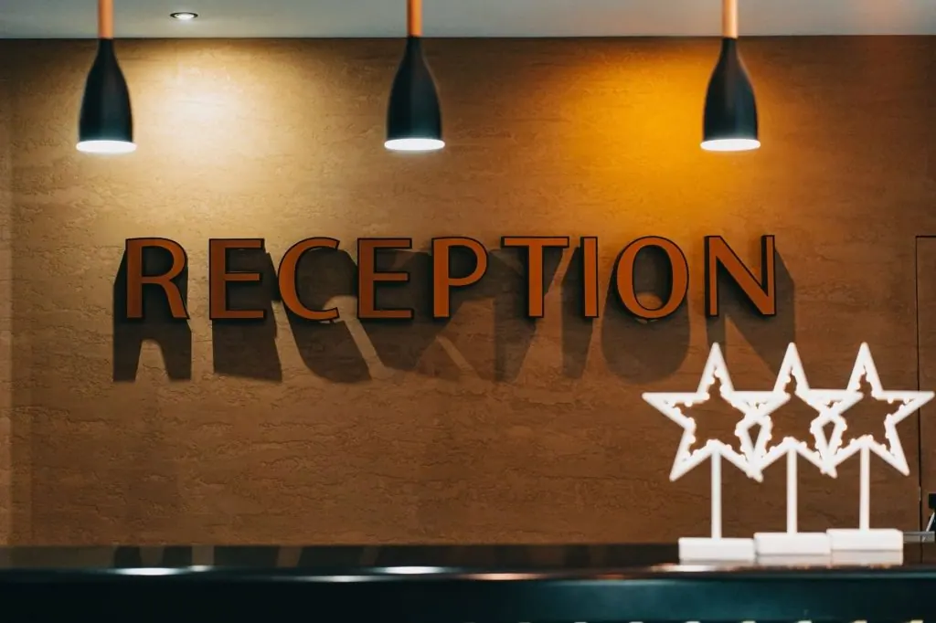 Elegant hotel reception area with illuminated signage and decor.